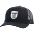Black trucker cap seen from the front at a slight angle. A white shield logo patch reading Martin Saddlery sits on the front panels, with a precurved bill and a black mesh back.