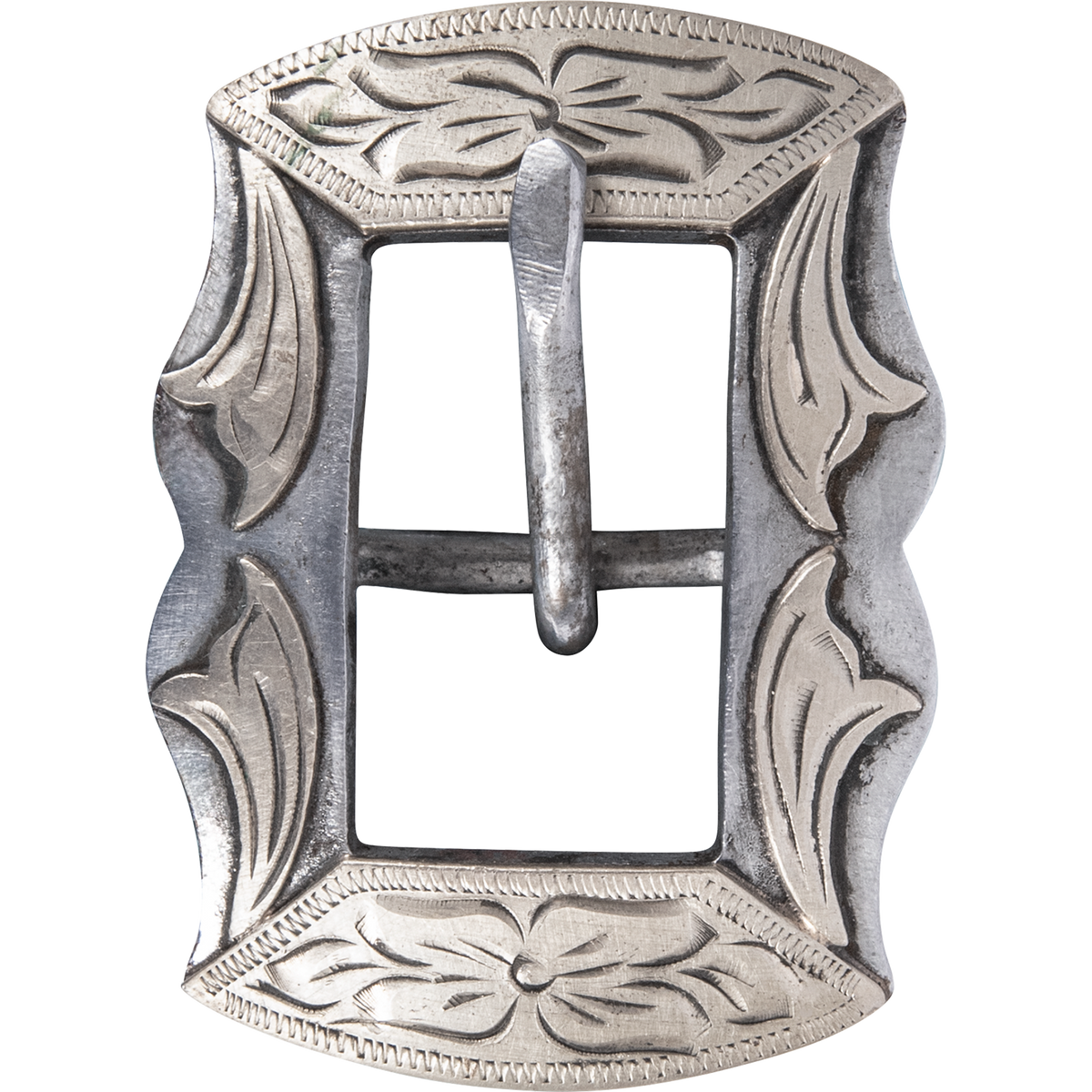 Prescott buckle from a chocolate roughout headstall, seen up close. The buckle is engraved with floral and leaf patterns around a center bar and tongue.