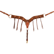 Chocolate roughout breastcollar with rosette blood knots, seen from the front in full. Antiqued rosettes with long strings sit along the 2.75-inch shoulder straps, which meet at a center ring above a tie-down strap with a snap.
