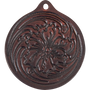 Floral leather air freshener from Martin Saddlery, seen from the front. A tooled flower with swirling leaves fills the round dark brown leather, with a hole at the top for hanging.