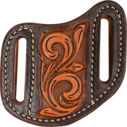 Dyed edge leather knife sheath with vine tooling, seen from the front. A natural tooled panel sits between dark dyed sides, each with a belt slot outlined in white stitching.