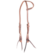 Natural slip ear headstall with rawhide lacing, seen from the front quarter. Rawhide lacing accents the ear loop and cheeks of the harness leather headstall, which ends in dark bit ties.