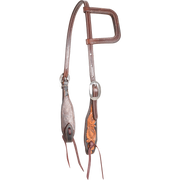 Dyed edge and tooled slip ear headstall, seen from the front quarter. Natural floral tooling fills the shaped cheek ends inside dark dyed edges, with a stitched ear loop, buckles and bit ties.