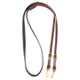 BioThane barrel rein from Martin Saddlery, coiled and seen from above. The black non-slip BioThane grip joins latigo leather ends with buckles for length adjustment and snaps.