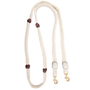 White blended mohair barrel rein, coiled and seen from above. The braided mohair rein has dark latigo leather knots along both sides and ends in buckles with snaps, made by Martin Saddlery for barrel racing.