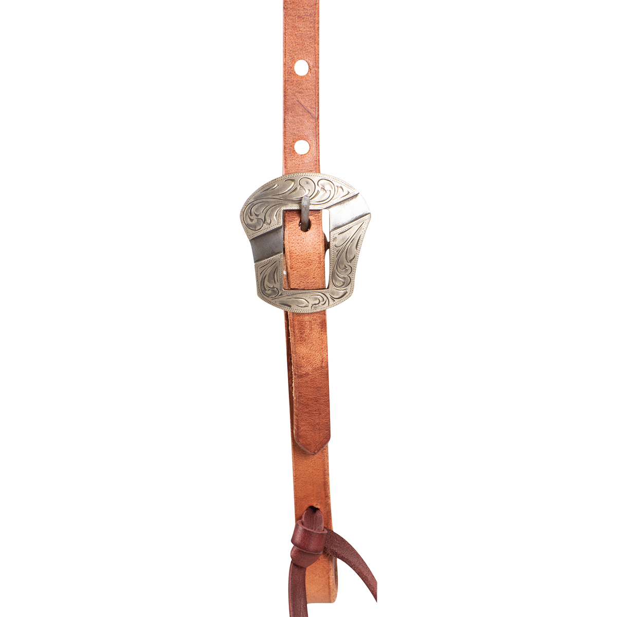 Engraved Salinas buckle on a natural harness leather headstall, seen up close. Scrollwork covers the shaped buckle frame, with adjustment holes above and a latigo bit tie below.