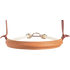 Tan chap leather cover of a single rope noseband, seen from the front. White stitching runs along the smooth natural leather, with white rope and a metal connector behind.