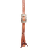Harness leather headstall cheek seen up close, with an engraved Prescott buckle above a latigo bit tie. White stitching follows both edges of the strap.