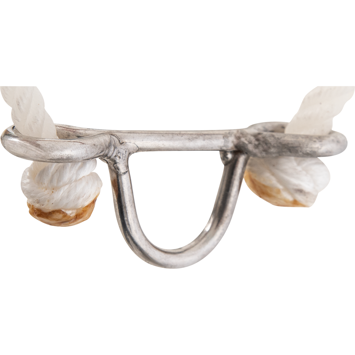 Metal attachment loop on a rope headsetter, seen up close. White rope knots sit at each end of the bar, with the loop hanging below for a tiedown strap.