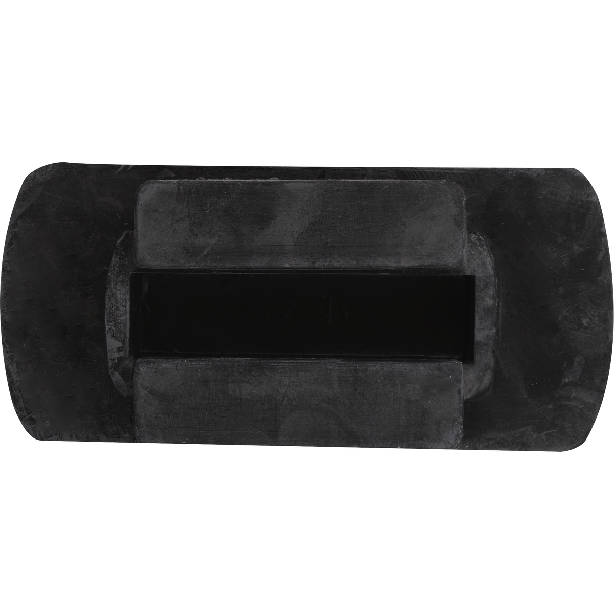 Underside of a rubber stirrup tread insert, seen from above. A raised mounting block with a center slot sits on the flat black base.