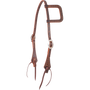Weathered antique slip ear headstall, seen from the front quarter. The skirting leather has a weave stamp on the ear loop and shaped cheek ends, with cart buckles and latigo bit ties.